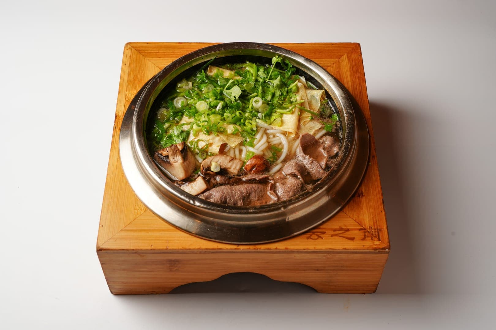 Slow-simmered Yunnan soup captured in warm editorial lighting
