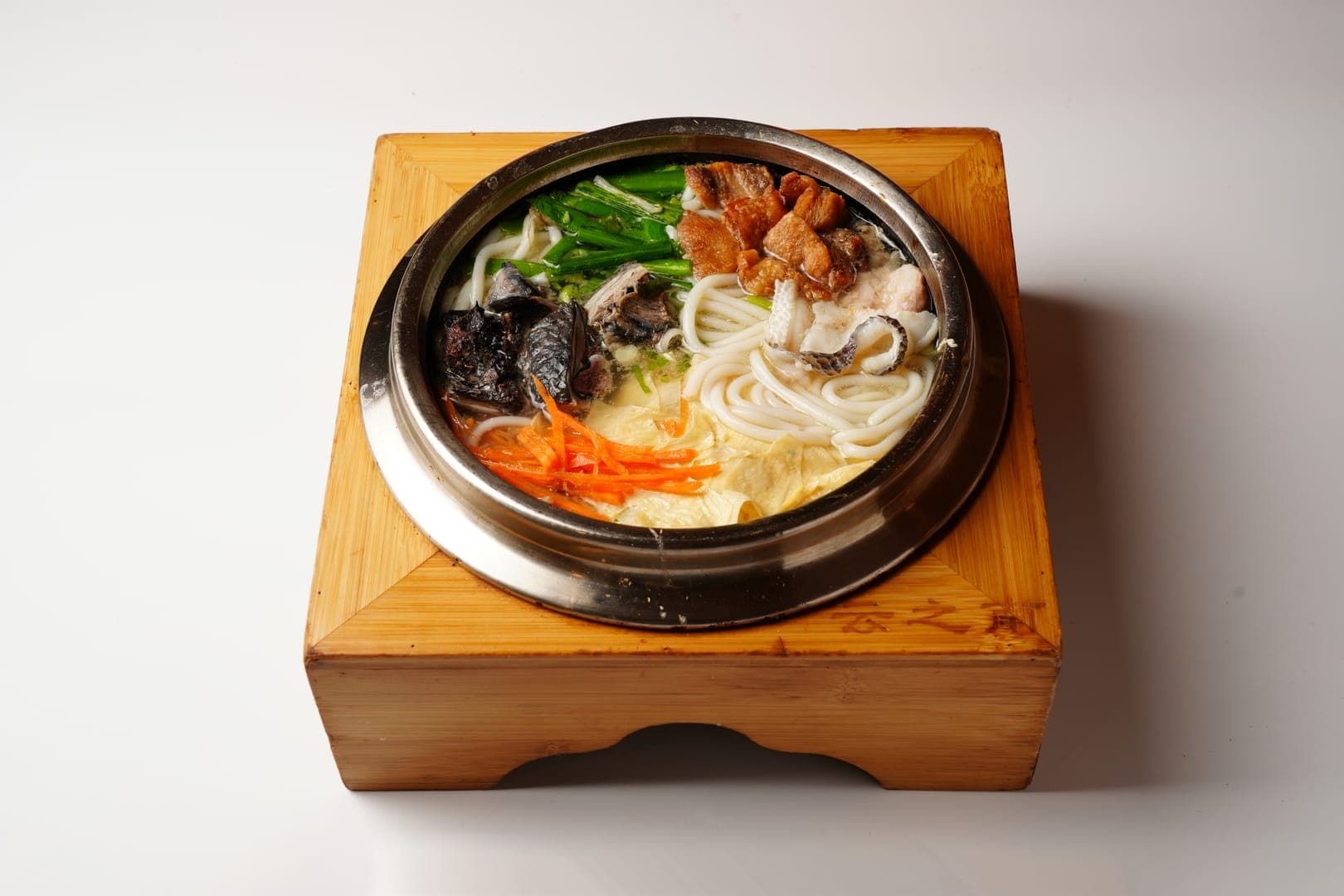 Slow-simmered Yunnan soup captured in warm editorial lighting